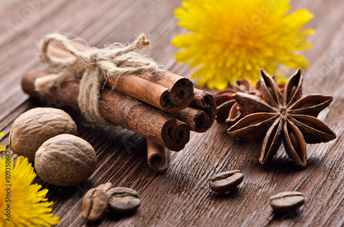 spices from coffee beans and flowers on the wooden background