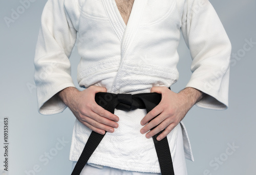Martial arts Master with black belt in white kimono