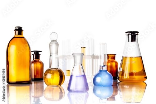 Test glass flask with solution in research laboratory. Science and medical background. Focus in the foreground.
