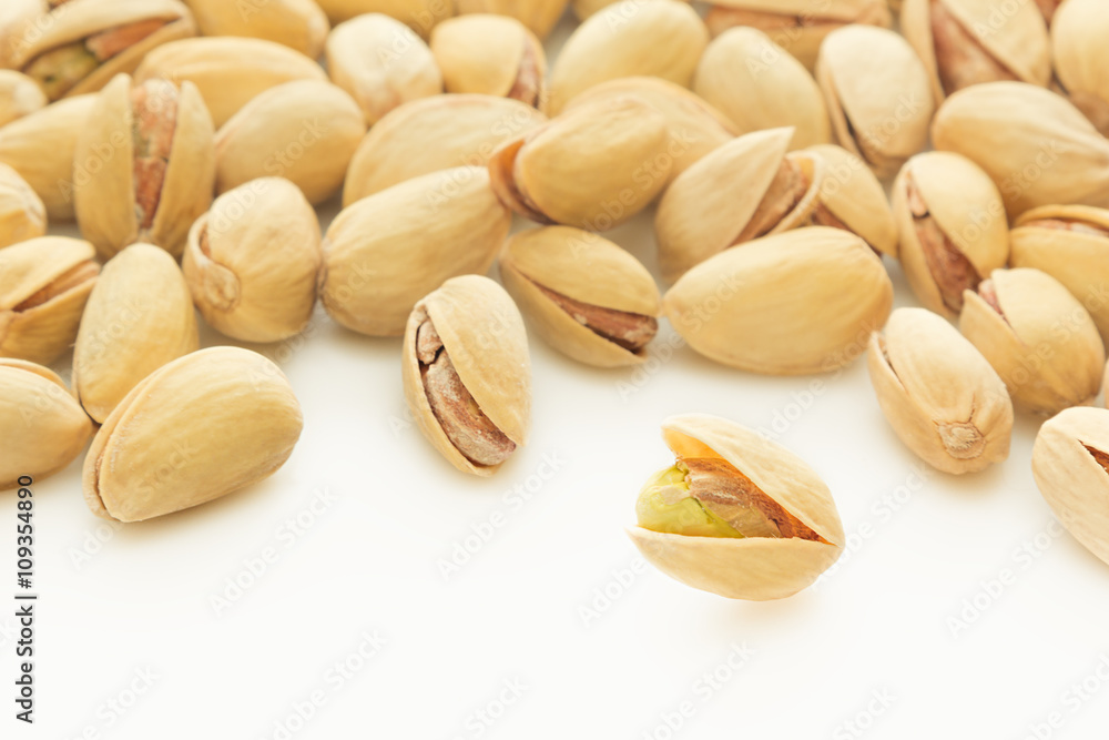 The pistachios on white background. The pistachio background. The pistachios on white background. The pistachio background.