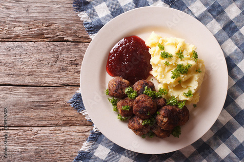 fried meatballs, lingonberry sauce with potato garnish. Horizontal top view
 photo