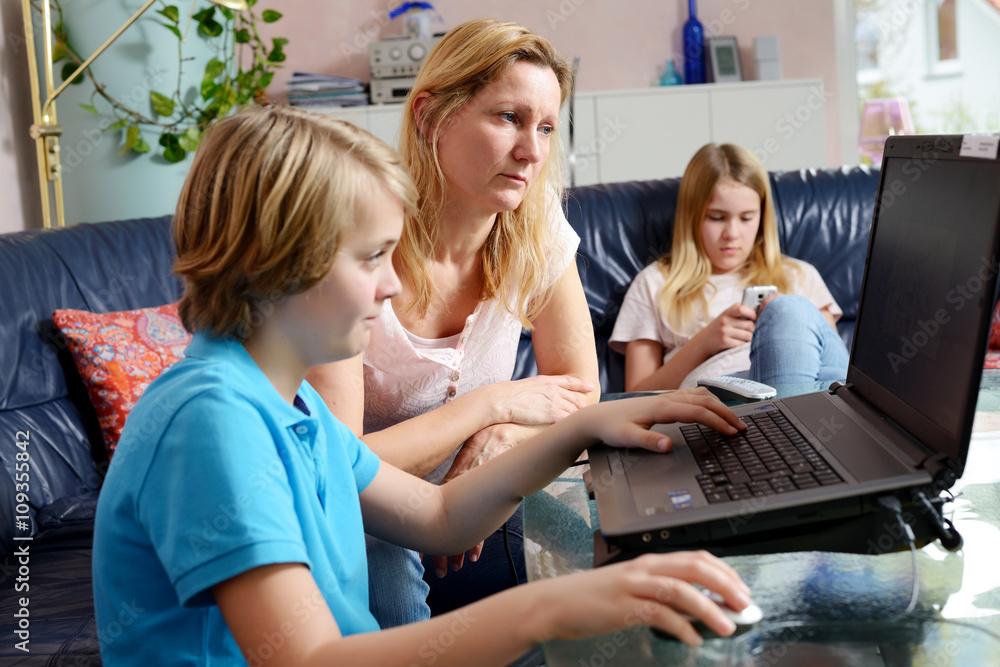 mother and her children using computer mother and her children using computer