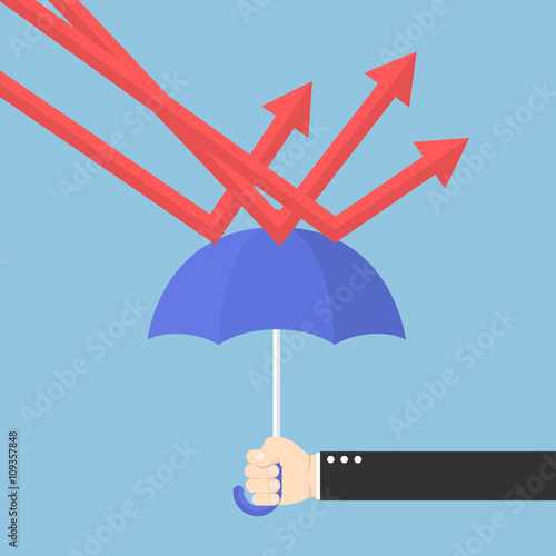 Businessman hand using umbrella to protect downtrend graph