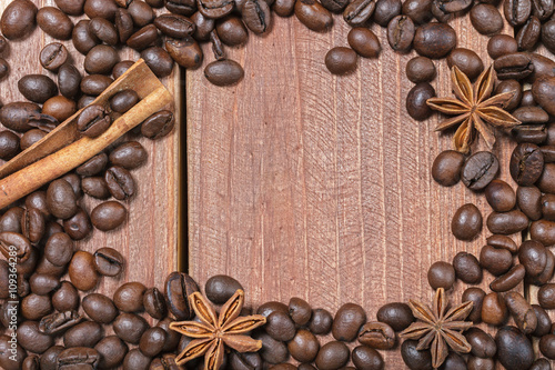 Coffee beans and spices on a wooden table