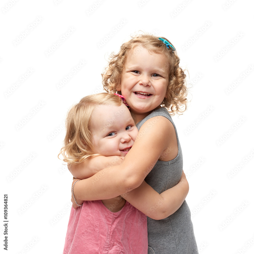 Couple of young little girls standing over isolated white background Couple of young little girls standing over isolated white background