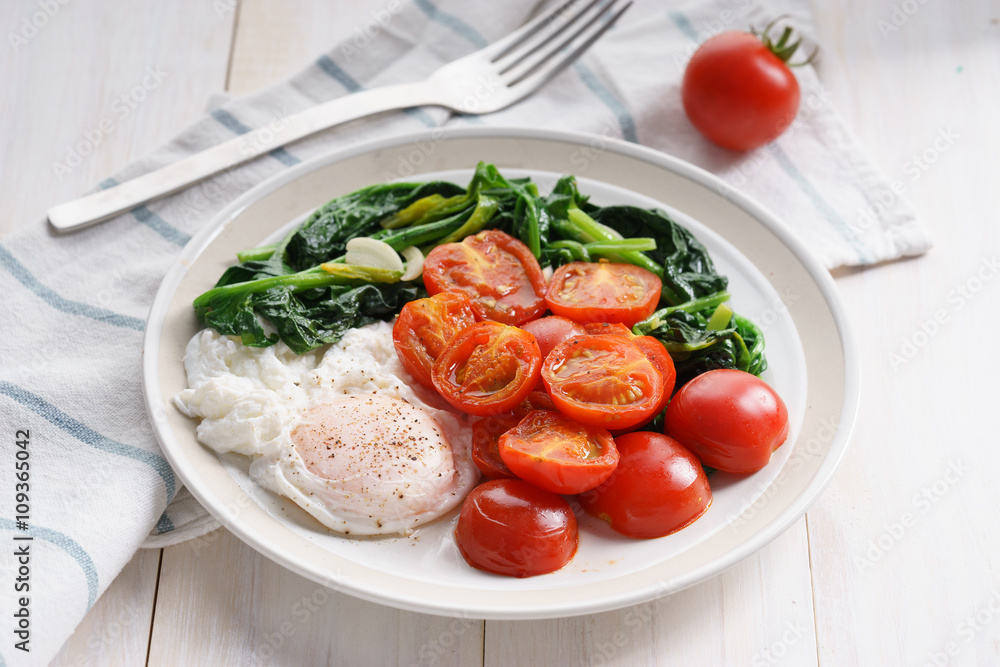 tomato and spinach salad with egg.