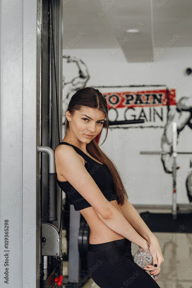 Beautiful girl with water at the gym