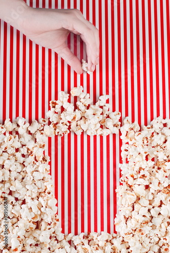full box of popcorn on a striped background