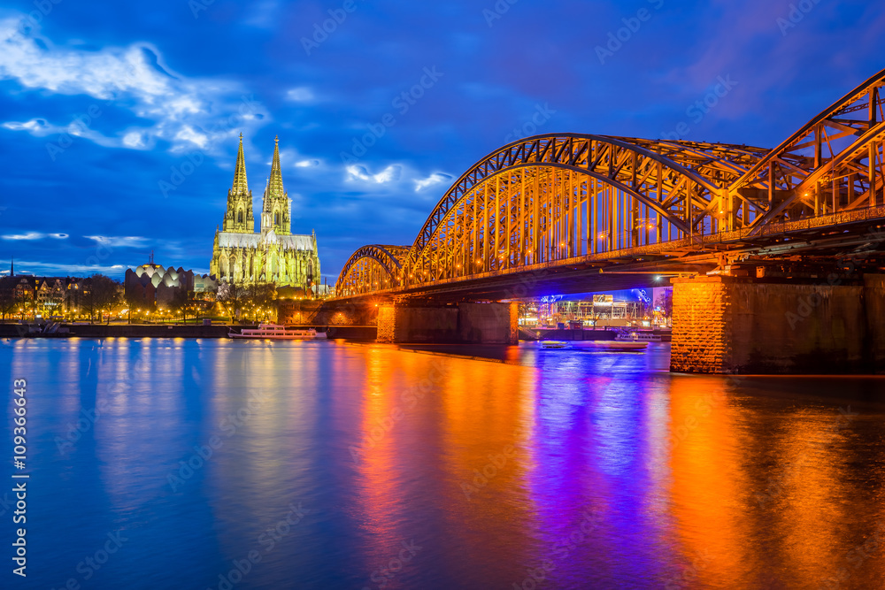 Night at the Cologne Cathedral with Hohenzollern Bridge in Colog