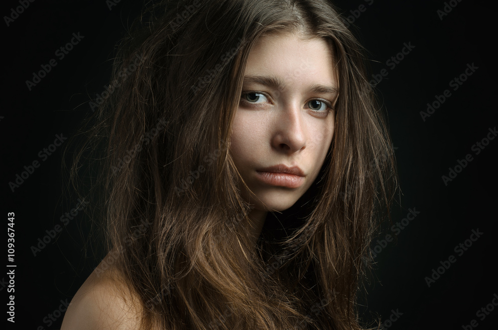 Dramatic portrait of a girl theme: portrait of a beautiful girl on a background in the studio Dramatic portrait of a girl theme: portrait of a beautiful girl on a background in the studio