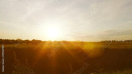 Driving through the countryside at dawn with bright sunshine