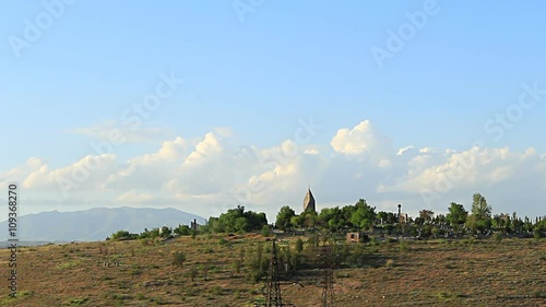 Yerablur. time lapse moving white clouds in a landscape church located on Mount ambient trees photo