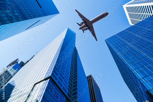 airplane over office buildings
