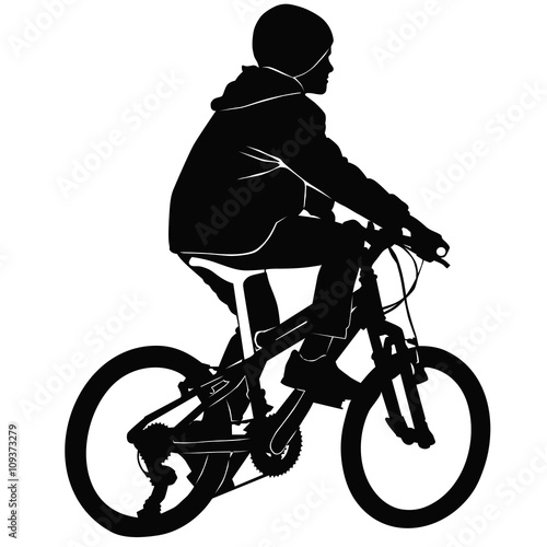 Boy riding a bicycle in black and white