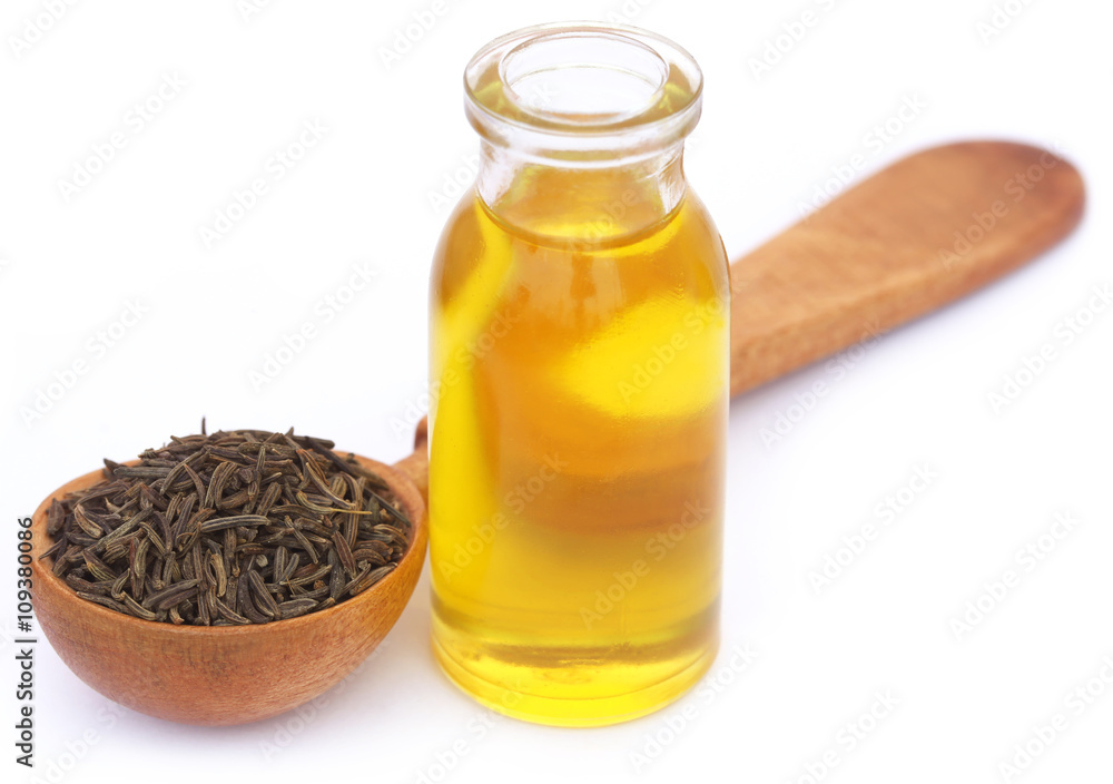 Caraway seeds with essential oil in glass bottle Caraway seeds with essential oil in glass bottle