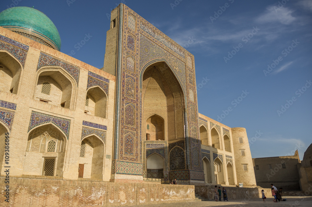 Decorated with traditional ornament facade of Mir-i Arab Madrasah in susnset, Historic centre of Bukhara, Uzbekistan (UNESCO World Heritage)