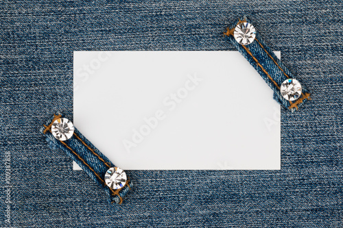 Photo Business card with two straps  jeans, lies on the light denim