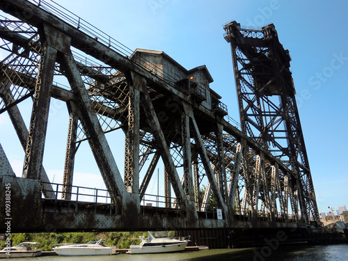 Rusty old industrial railroad lift bridge over Chicago canal - landscape color photo photo