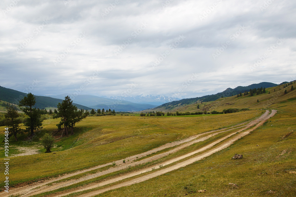 gravel road in a mountain valley at the top of the Altai Mountains 