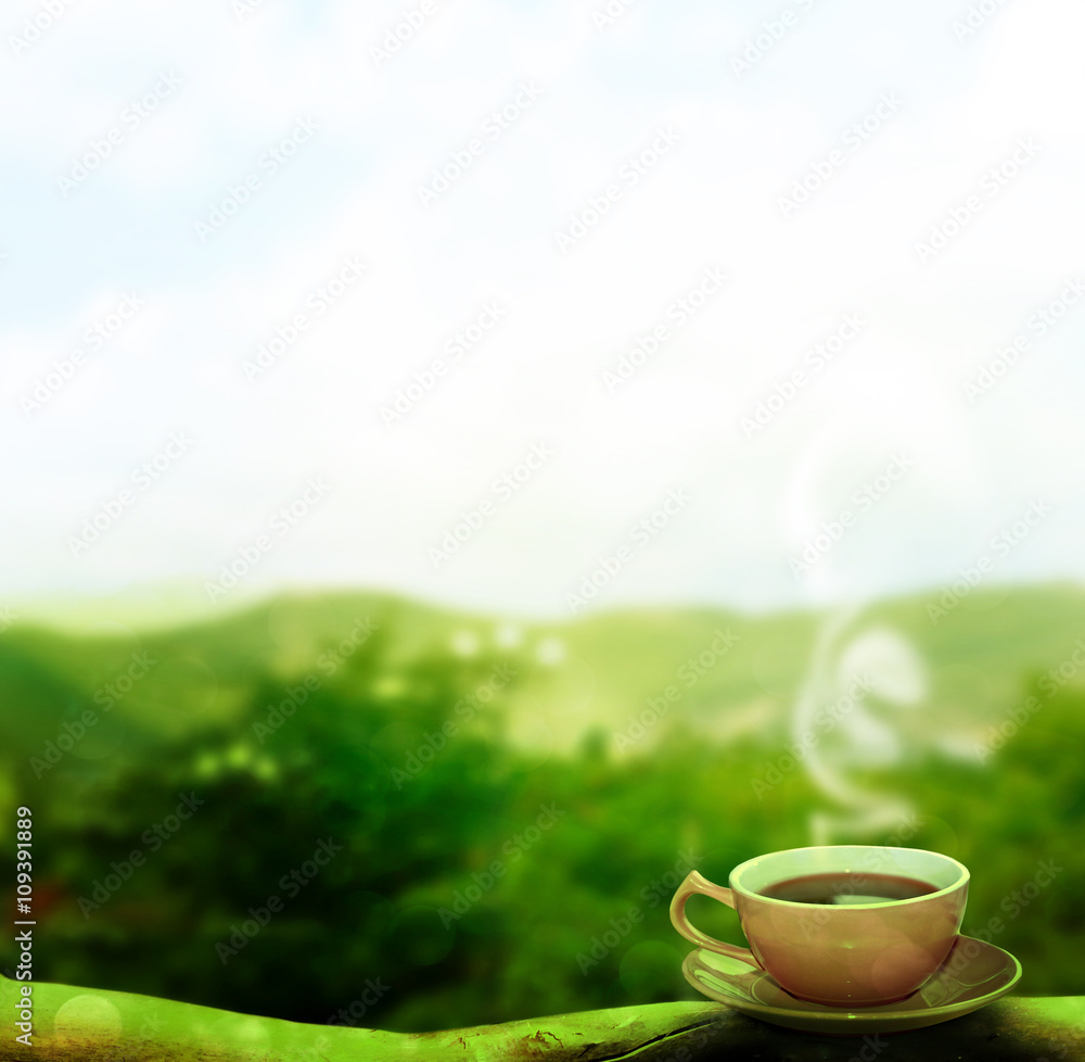 Cup of hot tea on a background summer landscape Cup of hot tea on a background summer landscape