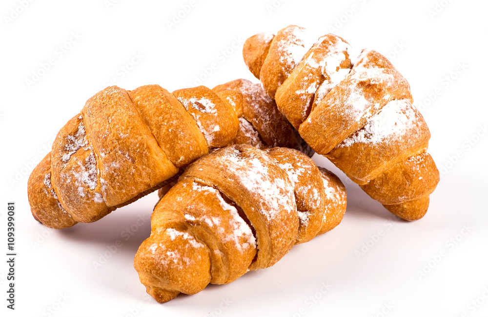 pile of fresh and delicious kroissants and rolls on a white back