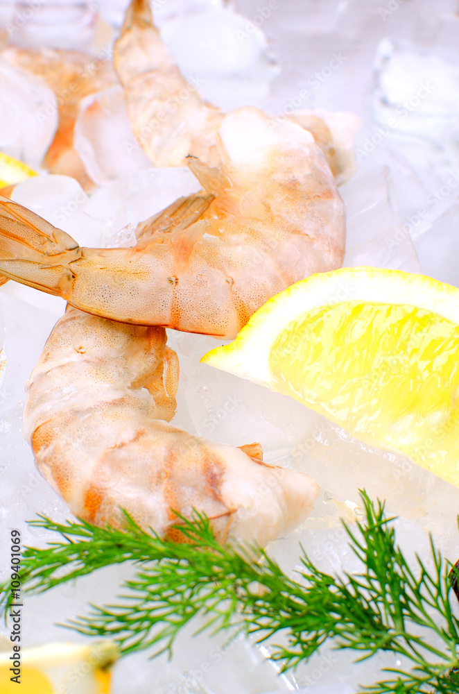 Raw shrimp on ice with lemon Raw shrimp on ice with lemon