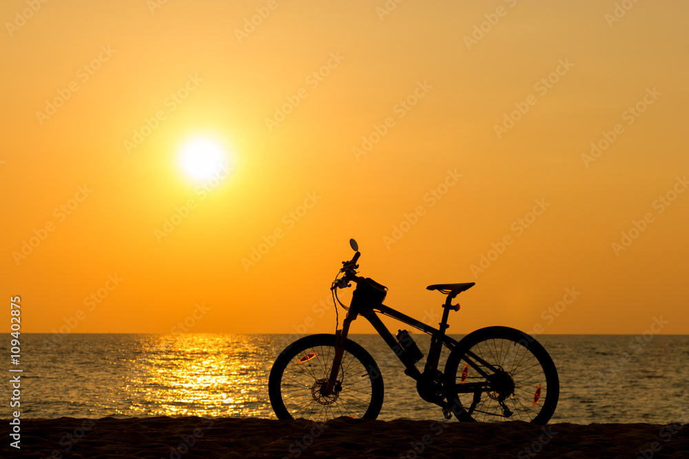 Mountain bike on the beach and sunset