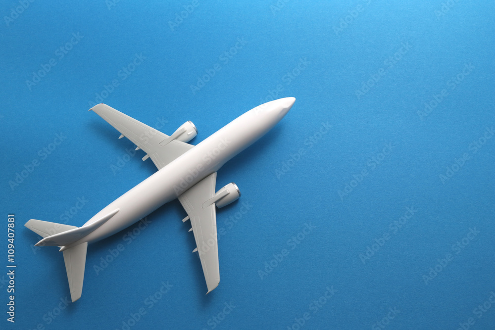 Toy airplane on blue background.
Toy airplane on blue background.