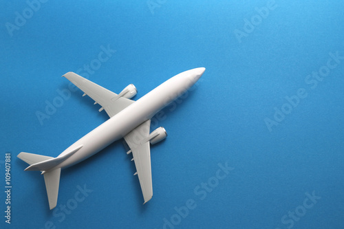Toy airplane on blue background. 