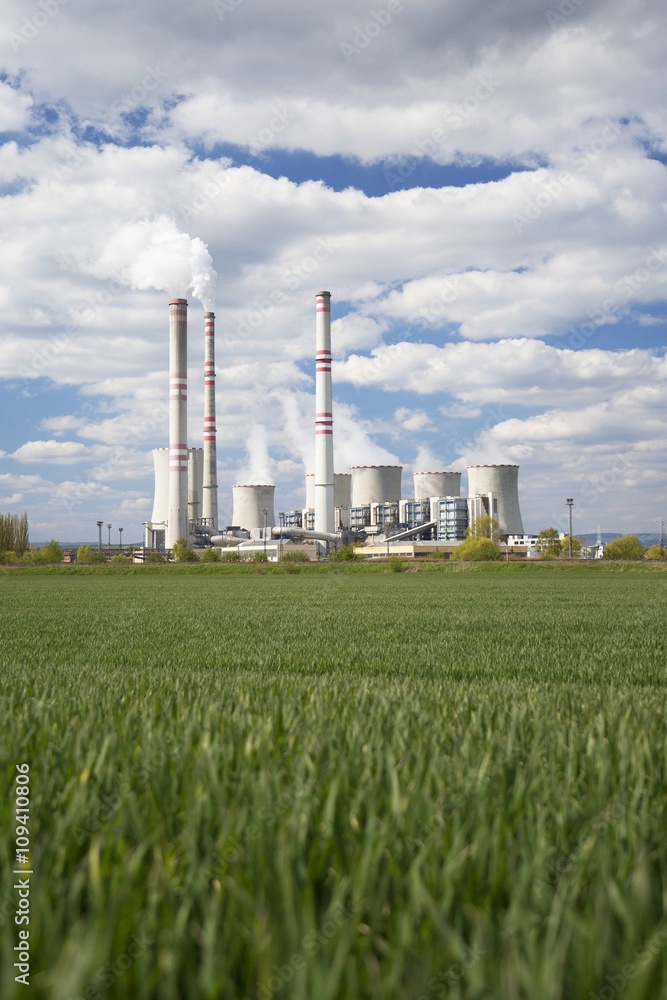 A coal-fired power station in the distance in agricultural landscape. Pocerady, Czech republic