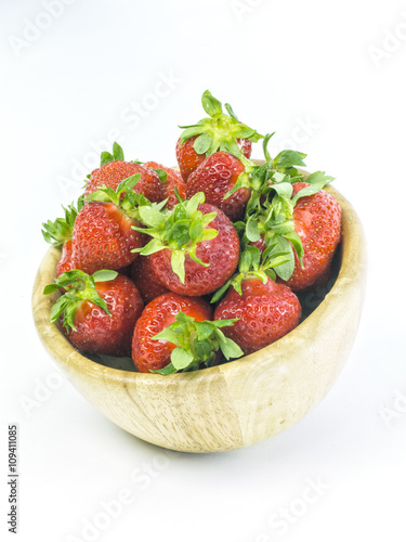 fresh whole strawberries in wooden bowl