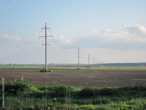 Supports power lines of 110 kV in the spring in a plowed field