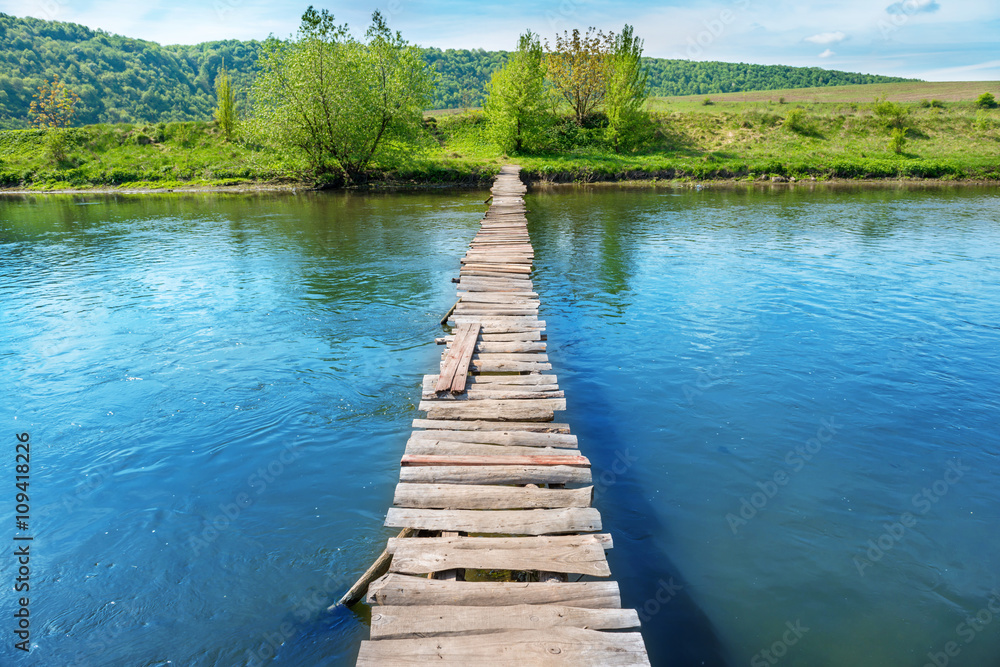 Old wooden bridge through the river Old wooden bridge through the river