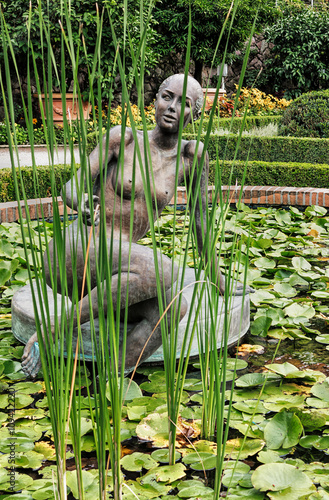 Woman sculpture in lily pond in gardens of the Trauttmannsdorf Castle. Merano, South Tyrol photo