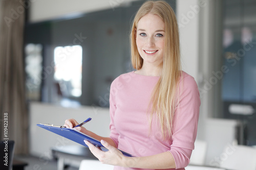Blond businesswoman working at office photo