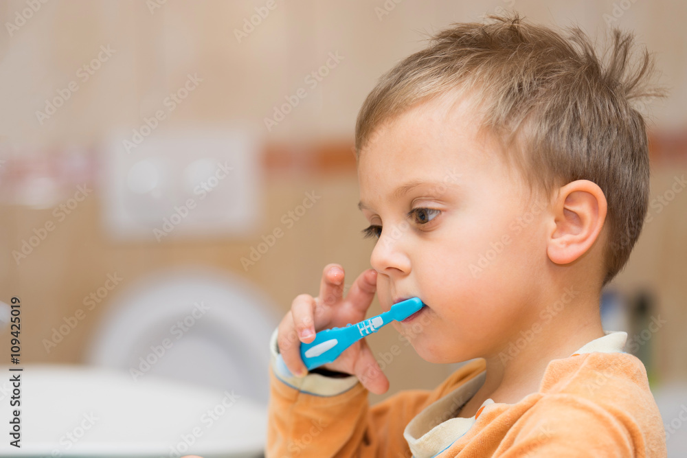 child is brushing teeth in bathroom child is brushing teeth in bathroom