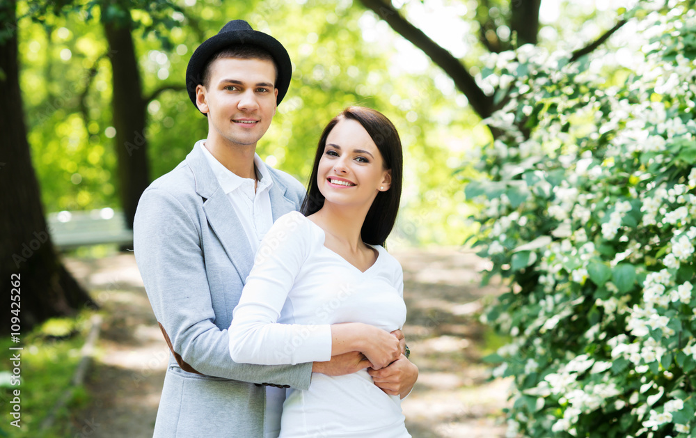 Young beautiful couple posing in the park Young beautiful couple posing in the park