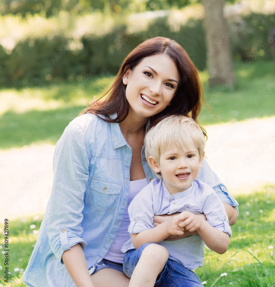 Gorgeous mother playing with her son in the park Gorgeous mother playing with her son in the park