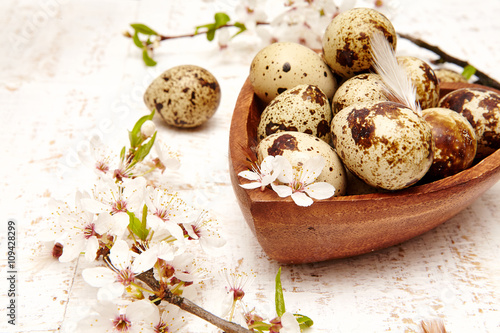 Spring easter composition with eggs and cherry flowers on a white old wooden background 