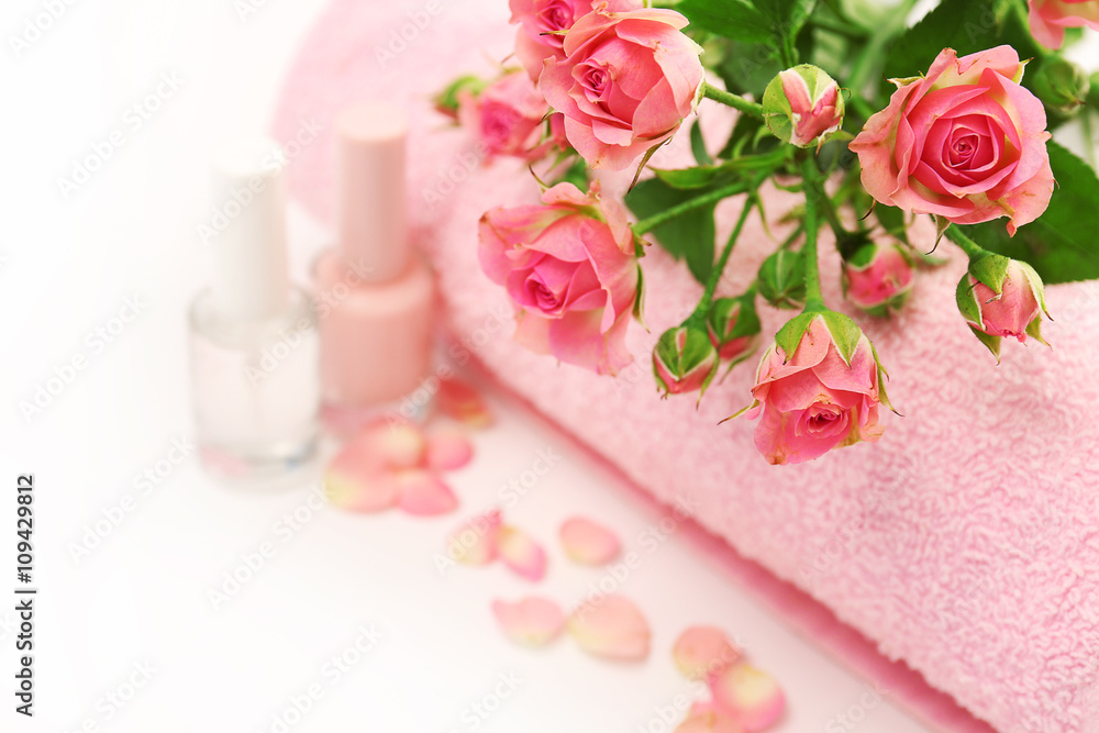 Spa concept. Flower bouquet and towel on white background Spa concept. Flower bouquet and towel on white background