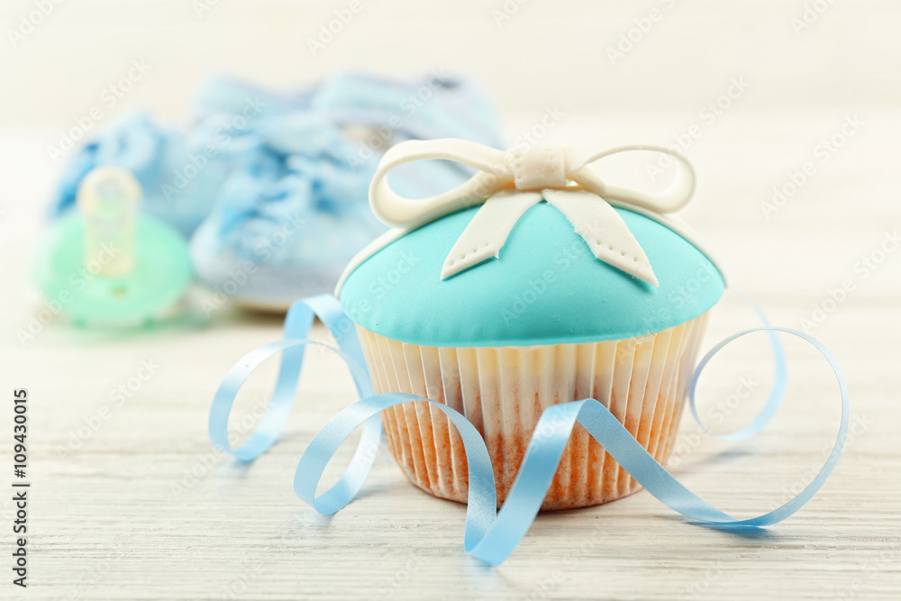 Tasty cupcake with bow on light background Tasty cupcake with bow on light background