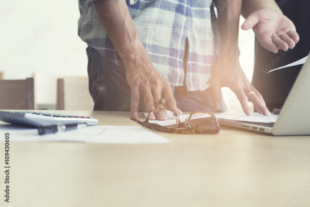 Fototapeta premium men working with calculator, business document and computer note