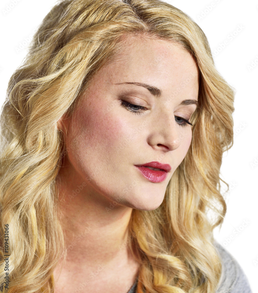 Beautiful blond woman looking down. Young, sad or thinking looking woman with copy space, isolated on white background. Beautiful blond woman looking down. Young, sad or thinking looking woman with copy space, isolated on white background.