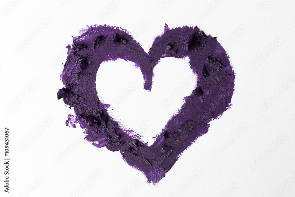 Purple lipstick smeared in heart shape isolated on white background, close up