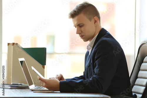 Man using laptop and smart ...