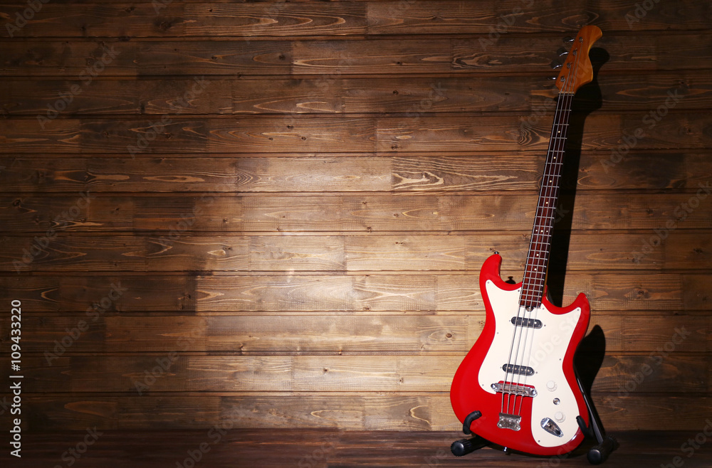 Fototapeta premium Electric guitar on dark lightened wooden background