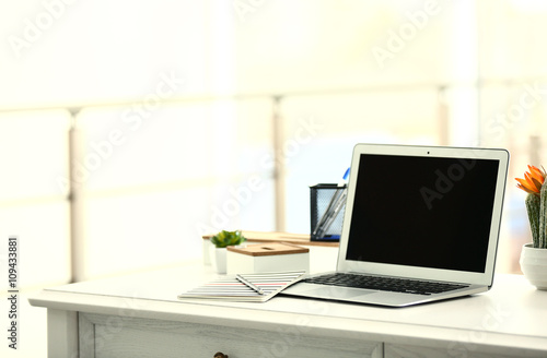 Laptop on the table in the office © Africa Studio