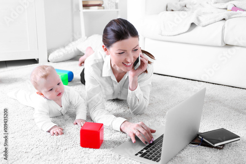 Businesswoman with baby boy...