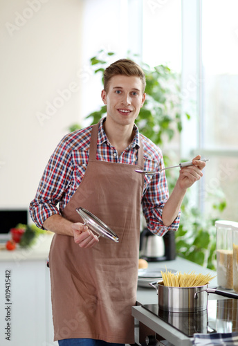 Happy handsome man cooking ...