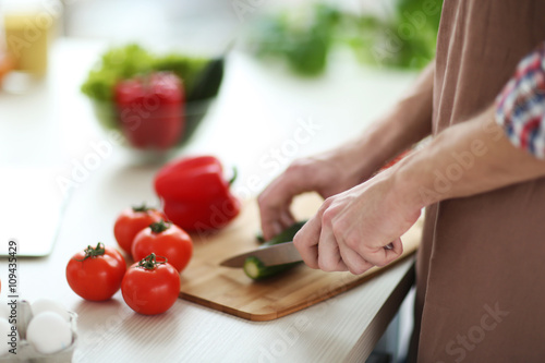 Man chopping vegetables in ...
